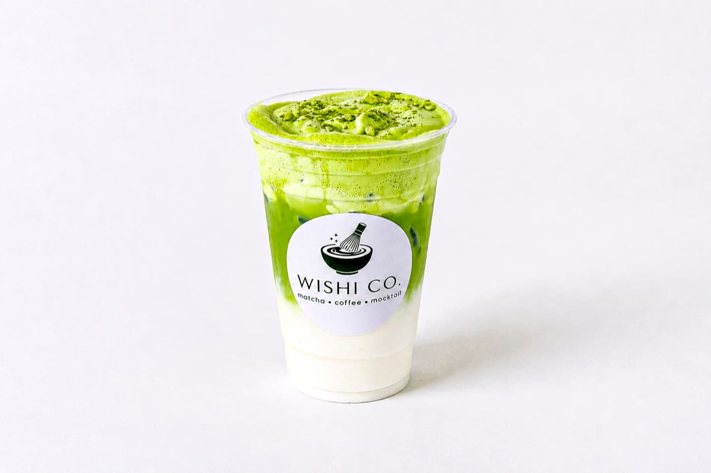 An iced stone-ground matcha latte with cream cold foam at Wishi Co. in Minneapolis.